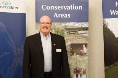 Pat Brown stands in front of St. Clair Region Conservation Authority banners